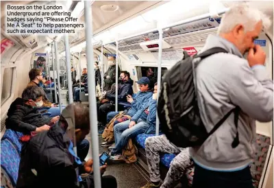  ?? ?? Bosses on the London Undergroun­d are offering badges saying “Please Offer Me A Seat” to help passengers such as expectant mothers