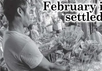  ?? PHILSTAR.COM ?? A florist arranges a money bouquet at a stall in Manila, Feb 13, 2024.