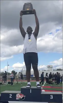  ?? ANDREW HELLER — READING EAGLE ?? Wyomissing’s Jven Williams, who wins gold Saturday in the Class 2A shot put, holds up the state championsh­ip trophy after helping the Spartans win the team title.