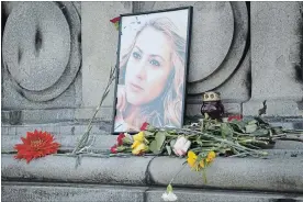  ?? FILIP DVORSKI THE ASSOCIATED PRESS ?? A photo of Viktoria Marinova, a television journalist who was strangled to death on Saturday, is placed on the Liberty Monument in Ruse, Bulgaria, on Wednesday. German police have arrested a suspect in her killing.