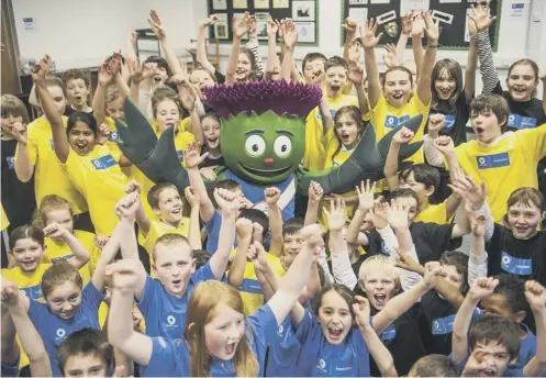  ??  ?? 0 Commonweal­th Games mascot Clyde is greeted by children at Forrester High School in Edinburgh in the run-up to the Glasgow event