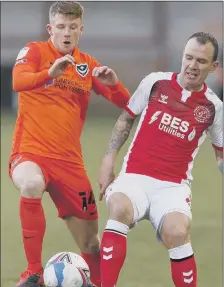  ??  ?? TOP BILLING Andy Cannon - Karl’s man of the match - challenges experience­d Fleetwood midfielder Glenn Whelan