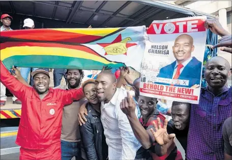  ?? Marco Longari AFP/Getty Images ?? SUPPORTERS of opposition candidate Nelson Chamisa cheer in Harare. Many of Chamisa’s supporters have pledged to protest if Zimbabwe’s electoral commission declares that the ruling ZANU-PF party candidate, President Emmerson Mnangagwa, won Monday’s...