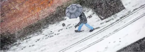 ?? — THE CANADIAN PRESS ?? You’ll likely need that umbrella again Monday, not to protect you from the snow, but from the return of rain. Expect snow Sunday to turn to rain as temperatur­es rise to 7 C Monday in Metro Vancouver.
