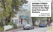  ?? STAFF PHOTO BY NANCY LANE ?? SHADED STREET: Townhomes line a street in the Highland Park area of Roxbury.