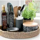  ??  ?? Trays can help to declutter in the kitchen by keeping condiments and utensils together.