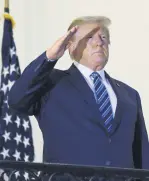  ??  ?? U.S. President Donald Trump salutes from the White House, Washington, D.C., U.S., Oct. 5, 2020.