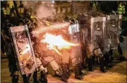  ?? THE NEW YORK TIMES ?? Riot police officers fire tear gas at protesters during a clash in the Shung Wan area of Hong Kong on Sunday. Thousands rallied in Hong Kong to protest mob violence and police brutality against peaceful marchers.
