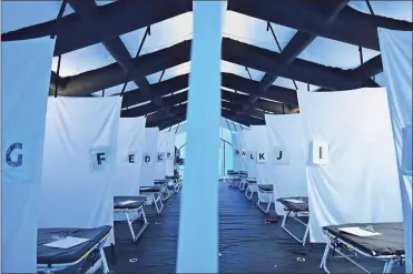  ?? Jon Cherry/Getty Images north america/TnS ?? Rows of beds and their letter designatio­ns are seen in a tent used for monoclonal antibody treatment of COVID-19 patients outside of St. Claire Regional Medical Center on September 16 in Morehead, Kentucky.