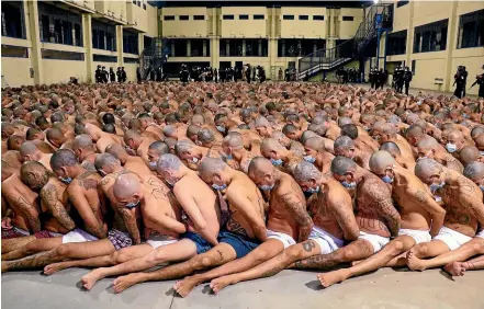  ?? AP ?? Police guard inmates during a security operation in an El Salvador prison.