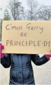  ??  ?? Placard Message to University principle Gerry McCormac
