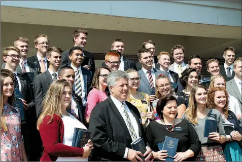  ??  ?? Norman and Karen Hansen (front center), leaders of the Arkansas Little Rock Mission of the Church of Jesus Christ of Latter-day Saints, stand with some of its missionari­es as Renee Carr (not pictured), director of public affairs for the church, takes a...