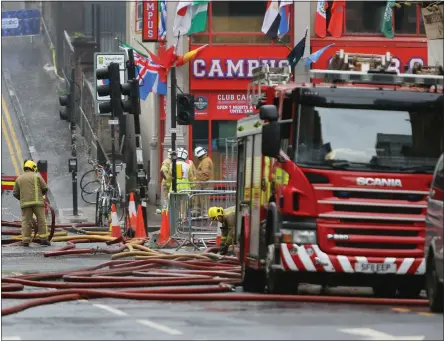  ??  ?? Firefighte­rs on the scene in Sauchiehal­l Street, and below right, the fire last Friday night