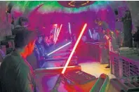  ?? JAY L. CLENDENIN/LOS ANGELES TIMES ?? Visitors to Savi’s Workshop are guided in building lightsaber­s.