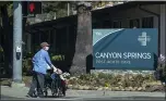  ?? KARL MONDON — STAFF PHOTOGRAPH­ER ?? A person is wheeled toward Canyon Springs PostAcute Care in San Jose on Wednesday.