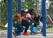  ?? Mark Mulligan / Staff photograph­er ?? Willie Hilliard pushes his daughter, Celebrity, 7, at Hermann Park, which will get a $40 million facelift.