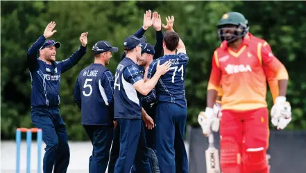  ?? Photograph: SNS ?? Scotland celebrate after Hamilton Masakadza is bowled out during their win over Zimbabwe