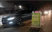  ?? PHOTOS BY CHARLES REX ARBOGAST/ASSOCIATED PRESS ?? DoorDash drivers line up outside the Northern Illinois Food Bank for their pickups in Park City, Illinois.