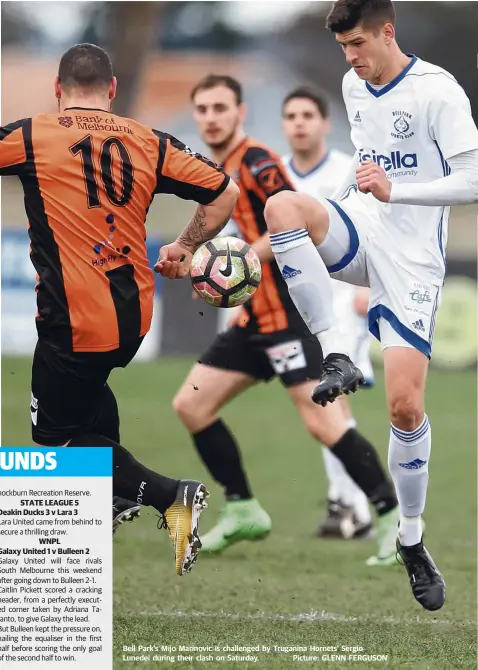  ??  ?? Bell Park’s Mijo Marinovic is challenged by Truganina Hornets’ Sergio Lunedei during their clash on Saturday. Picture: GLENN FERGUSON