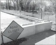  ?? Westside Eagle Observer/RANDY MOLL ?? With the bridge across Flint Creek closed and barricaded on Dawn Hill Road in Gentry because of April flooding, some have driven onto private property and through the creek rather than following the posted detours.