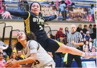  ?? ROBERTO E. ROSALES/JOURNAL ?? St. Pius’ Alyssa Maes (top) goes over the top of Highland’s Rebecca Neal on Friday night. The Sartans won in two OTs.