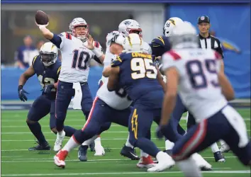  ?? John McCoy / Associated Press ?? New England Patriots quarterbac­k Mac Jones throws the ball while playing the Los Angeles Chargers on Oct. 31.