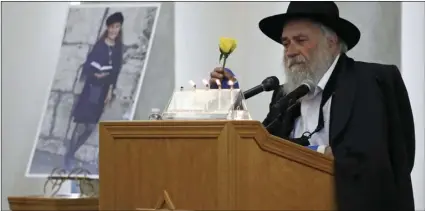  ?? PHOTO/GREGORY BULL ?? In this April 29 file photo, Yisroel Goldstein, Rabbi of Chabad of Poway, holds he speaks at the funeral for Lori Kaye (who is pictured at left) in Poway. AP