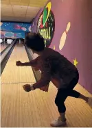  ?? ERIC SEALS/DETROIT FREE PRESS ?? Sophia George watches and dances as her ball nears the bowling pin to pick up the spare during a recent bowling match.