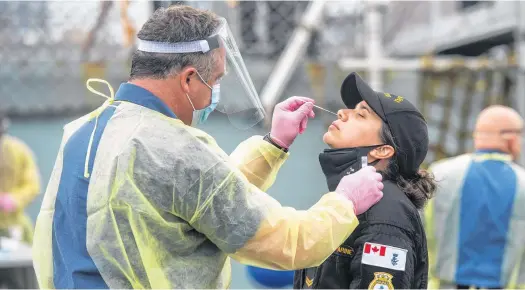  ?? RYAN TAPLIN • THE CHRONICLE HERALD ?? A sailor from HMCS Halifax gets a PCR test at CFB Halifax on Monday, July 19, 2021. The Halifax returned home on Monday as scheduled, however, a member of the crew tested positive for COVID-19 so the entire crew needed to get tested upon their arrival.