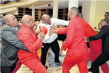  ?? Pictures: RANDELL ROSKRUGE ?? AT ARMS’ LENGTH: Members of the EFF were thrown out of the Bhisho legislatur­e on Tuesday, before the state of the province address was delivered, after complaints were made that they were inappropri­ately dressed in their red overalls.