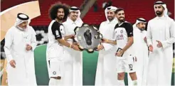  ?? PICTURES: Noushad Thekkayil ?? Al Sadd captain Hassan al-Haydos and forward Akram Afif receive QSL Shield from QFA president Jassim Rashid al-Buenain as QSL CEO Hani Taleb Ballan looks on yesterday.