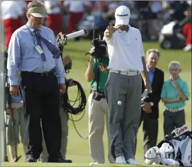  ?? AP PHOTO/LM OTERO ?? In this May 29, 2011, file photo, PGA rules official Slugger White (left) looks on as Ryan Palmer (right) drops his ball after hitting in the hazard during the first playoff hole of the Byron Nelson Championsh­ip golf tournament in Irving, Texas.