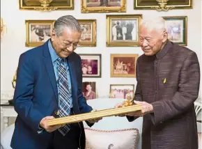  ??  ?? Longtime friends: Dr Mahathir receiving a token from President Privy Council Thailand General Prem Tinsulanon­da, 98, at his residence in Bangkok. Tinsulanon­da was the PM of Thailand from 1980 to 1988, the same time as Dr M became Malaysia’s PM in 1981.