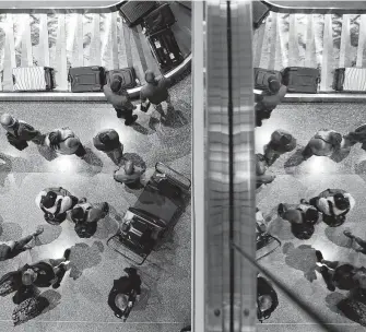  ?? John Locher / Associated Press ?? Passengers wait for baggage at McCarran Internatio­nal Airport in Las Vegas. Airlines and customers are looking at Senate and House versions of an FAA bill in Congress.