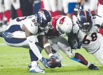  ??  ?? Zaire Anderson recovers a fumble by the Cardinals during the Broncos’ preseason finale in Glendale, Ariz., on Sept. 1. “The leverage I have helps me a lot,” he says. John Leyba, The Denver Post