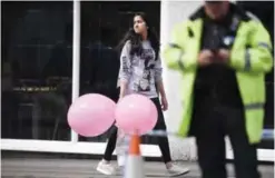  ??  ?? MANCHESTER: A girl wearing a T-shirt of US singer Ariana Grande carrying balloons from the Ariana Grande concert at the Manchester Arena leaves a hotel in Manchester, northwest England yesterday following a deadly terror attack at the concert at the...
