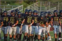  ?? Cory Rubin/The Signal ?? (Above) Golden Valley heads onto the field prior to a scrimmage against Crescenta Valley at Harry Welch Stadium Friday night. (Below) Quarterbac­k Zack Chevalier moves around in the pocket.