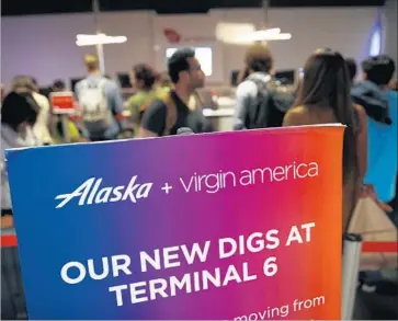  ?? Patrick T. Fallon For The Times ?? SIGNS ALERT passengers about the terminal changes at LAX as part of Delta Air Lines’ relocation to expand operations and allow better access to Tom Bradley Internatio­nal Terminal for itself and its partners.