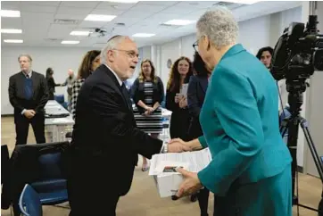  ?? ANTONIO PEREZ/CHICAGO TRIBUNE ?? Rabbi Abraham Cooper, the Simon Wiesenthal Center’s director of global social action, greets Cook County Board President Toni Preckwinkl­e following the Center’s release of a digital terrorism and hate report Friday.