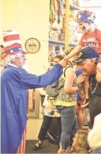  ??  ?? Uncle Sam greets a visitor to a previous Red, White and Blue Day.