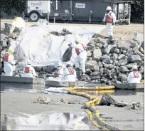  ?? RINGO H.W. CHIU — THE ASSOCIATED PRESS ?? Crews continue to clean up oil in the Talbert Marsh wetlands on Monday after an oil spill off the coast of Huntington Beach.