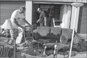  ?? SHARON MONTGOMERY-DUPE/CAPE BRETON POST ?? Jim Whalen of Mira, left, owner of East Coast Storage and Movers on Sydney Road in Reserve Mines, and his son Hughie help take furniture out of a storage unit for a customer who was in the process of moving. Whalen, who built his company from scratch 12 years ago, said there are all kinds of reasons people rent storage units.