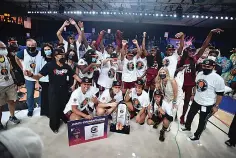  ?? Bahamas Visual Services via The Associated Press/Donald Knowles ?? South Carolina women’s basketball team celebrates with the trophy after defeating UConn 73-57 to win the championsh­ip game at the Battle 4 Atlantis in Paradise Island, Bahamas on Monday.