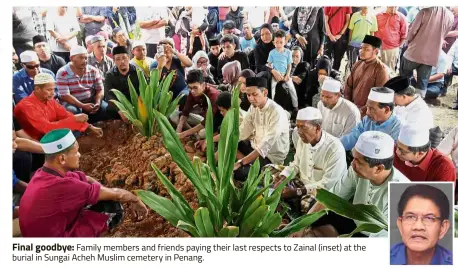  ??  ?? Final goodbye: Family members and friends paying their last respects to Zainal (inset) at the burial in Sungai Acheh Muslim cemetery in Penang.