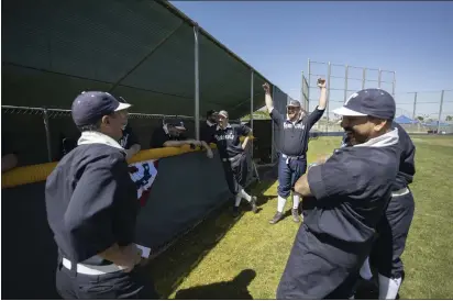  ?? PHOTOS BY ANDREW FOULK ?? Charles Gorzo, with arms upraised, and the rest of the Temecula Dear Bros chat during opening day of the Southern California Vintage Base Ball League on May 14 in Perris. The league’s eight teams play the game using rules and equipment much as they were in 1886.