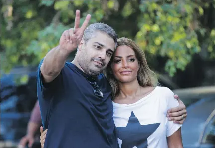  ?? AFP/GETTY IMAGES FILES ?? Canadian journalist Mohamed Fahmy, seen with his wife Marwa after his release last year from prison in Cairo, has written a book detailing his 438 days in custody for broadcasti­ng “false news.” He gives advice on how our government can help Canadians in foreign jails.