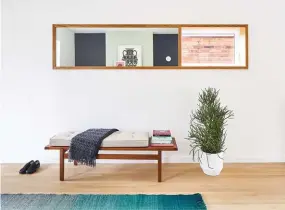  ??  ?? OPPOSITE Copper finishes warm the high-contrast kitchen. Pendants from EQ3; hardware from Schoolhous­e Electric and CB2; Rubinet faucet.
ABOVE White oak is the star here, trimming the window–mirror hybrid and running across the floors (by Graf Brothers). Bench from DWR; rug from Quasi Modo. BELOW Colour-blocking starts upon entry with a welcoming green-on-green focal wall and swathes of black and white. Mutina tile from Stone Tile covers the fireplace; art by Cleon Peterson and Sara Andreasson; armchair from Drechsel Studio.