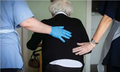  ?? Photograph: Murdo MacLeod/The Guardian ?? A resident is helped by care workers.