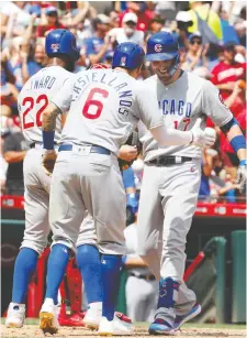  ?? DAVID KOHL/USA TODAY SPORTS ?? The Chicago Cubs’ Kris Bryant, right, celebrates with Nicholas Castellano­s and Jason Heyward after hitting a three-run home run against the Cincinnati Reds earlier this week.