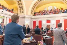  ?? CRAIG HUDSON/ASSOCIATED PRESS ?? West Virginia state senators acknowledg­e the cheers of teachers and school employees after the passage of a bill to increase pay of state personnel by 5 percent at the Capitol in Charleston on Tuesday.
